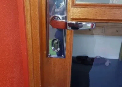 Brass oval lock cylinder on a timber door