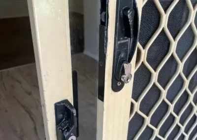 Black lock hardware on a white sliding door frame