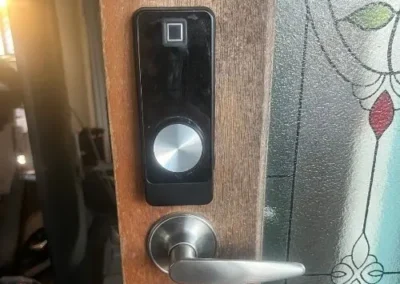 Silver lever handle with smart lock hardware on a timber door