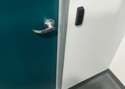 Hand using a key in a timber door lock