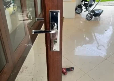 Hands holding a cylindrical door-lock component