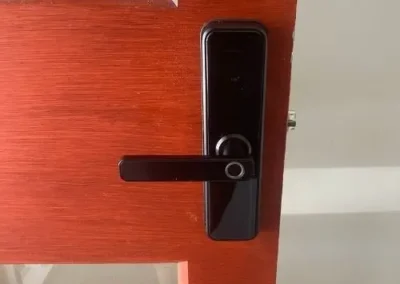 Silver lever handle and round lock cylinder on a timber door