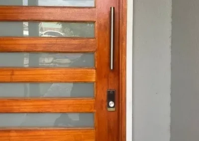 Chrome deadbolt and black lever on a screened door