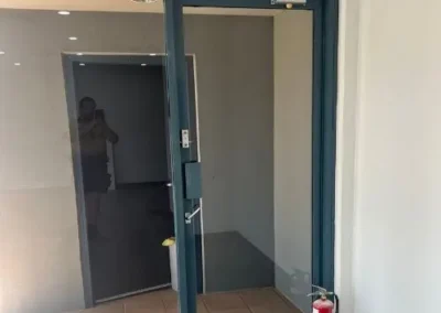 Overhead door closer fitted to an open commercial door