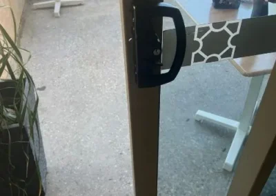 Black handle fitted to a security screen door
