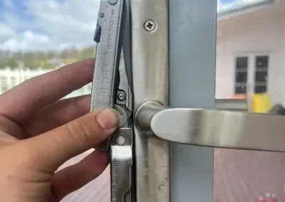 Silver lever handle being fitted to a door