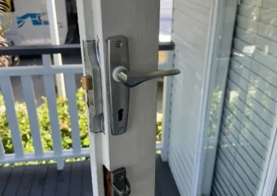 Handle and lock hardware on a security screen door