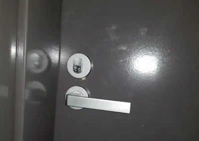 Silver lever handle and lock on a dark door