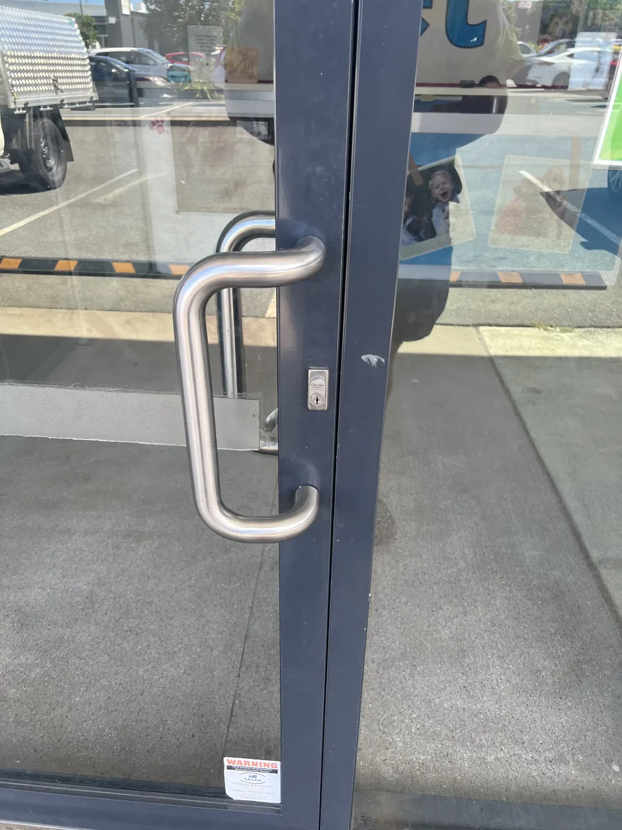 Lock and closer hardware on a fire door