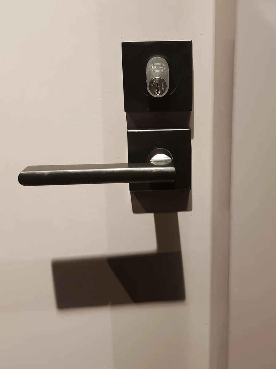 Black lever handle and lock on a cream door