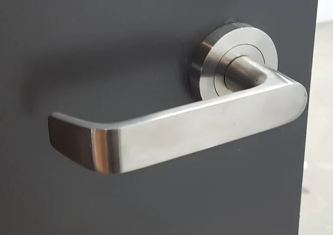Silver door lever on a dark door